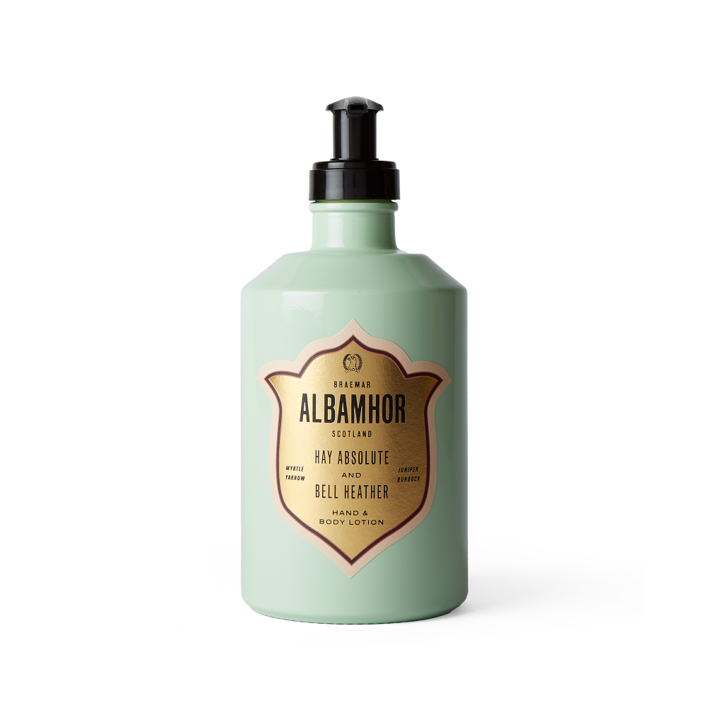 Mint green glass bottle of Albamhor hand and body lotion with a gold and pink label