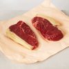 Beef rump steaks on paper