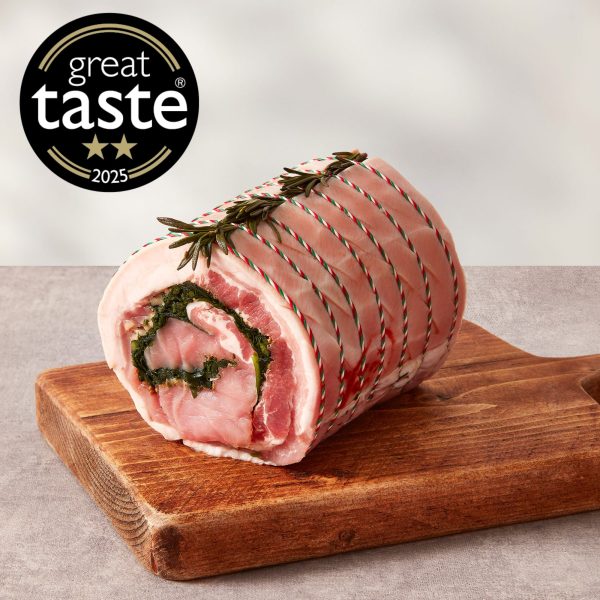 Porchetta with herb stuffing on a wooden chopping board