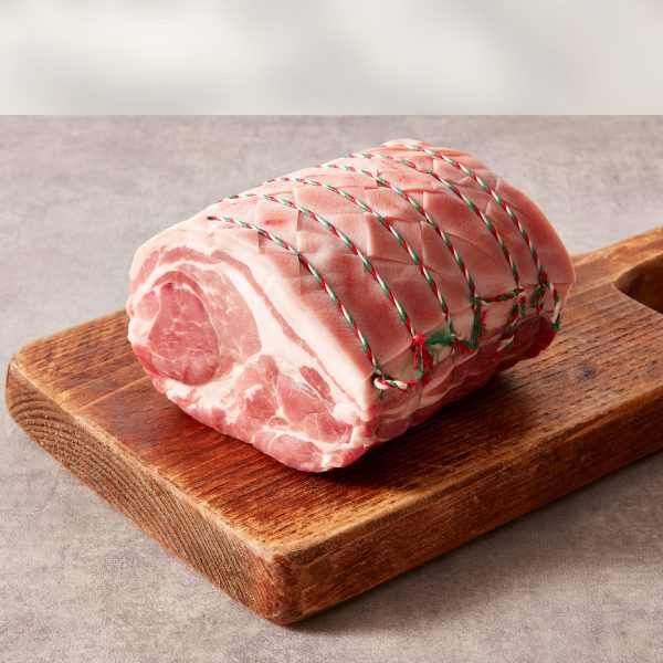 Pork shoulder on a wooden chopping board