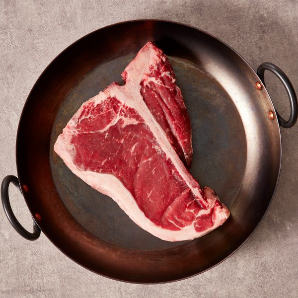T bone steak in a black skillet