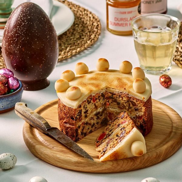 Easter simnel cake on a board with a slice cut out