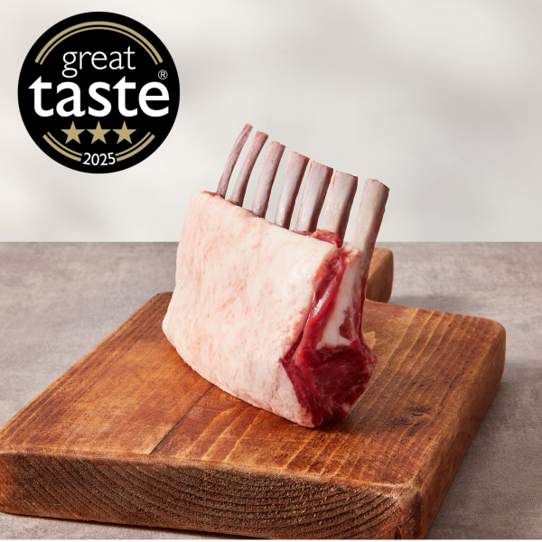 Trimmed rack of lamb on a wooden board
