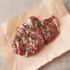 marinated butterflied lamb shoulder in pink butchery paper