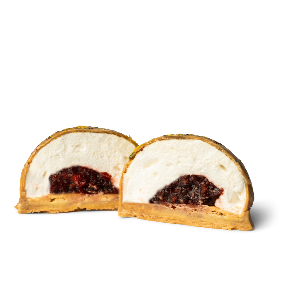 Blonde chocolate teacake cut in half with a raspberry jam and vanilla marshmallow filling